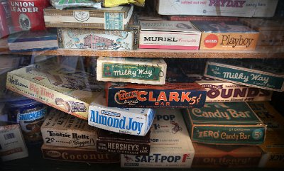 2015-10 Shea's (12) Vintage candy and cigar boxes-some possibly full- await the auctioneers gavel Nov. 21 inside the former Mahan's filling station on the museum property seen...