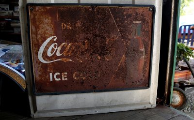 2015-10 Shea's (13) A vintage and heavily rusted Coca-Cola tin sign is seen on the front door of the former Mahan's filling station on the museum property seen Thursday, Oct. 1,...