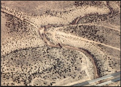 1944 Padre Canyon. I-40 is at lower right. Route 66 snakes in from west at lower left and turns north across the 1913 Luten span concrete bridge over Padre Canyon before turning east towards current Twin Arrows at top right.