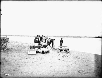 Small outboard being launched at Needles in the Colorado River, ca.1900 Photograph of a small outboard boat named Edith being launched in the Colorado River at Needles ca.1900. The boat is owned by George Wharton James. Two boys...