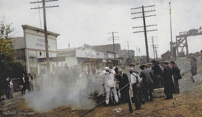 1914 Barstow - The man in white coveralls is mechanic George, and Barney is behind him in the car. You can see the old pedestrian bridge that went across the tracks.